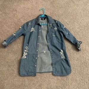 Distressed denim shirt.